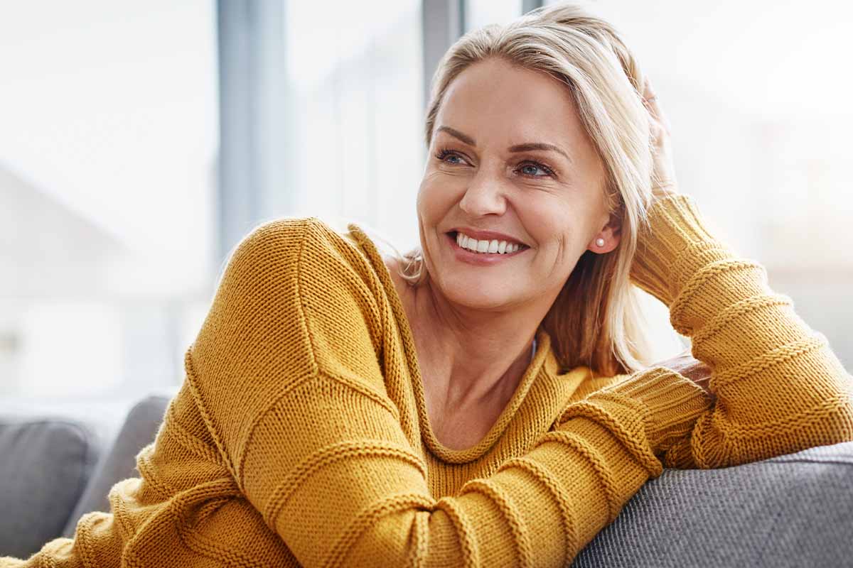 woman smiling after breast reconstruction in Connecticut.